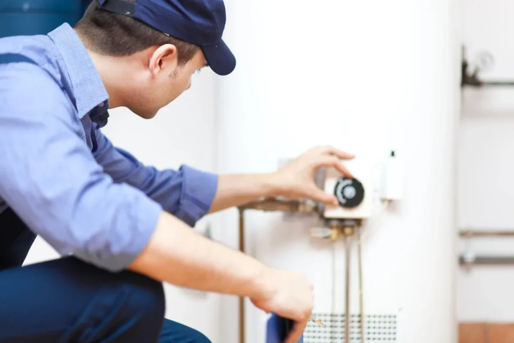 Boiler Installation in Belfair, WA 1 A technician wearing a proper gears and cap is maintaining a boiler